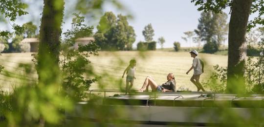 Momenten van vreugde en vrijheid met kinderen die lopen en lachen op het dak van een aangemeerd kanaalboot.